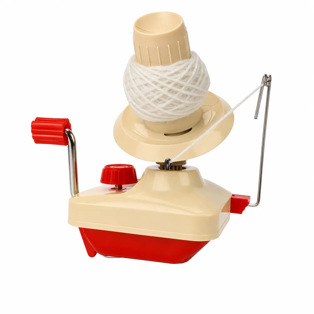 Close-up of the cream and red ball winder showing the crank handle on the geared base and the yarn guide arm